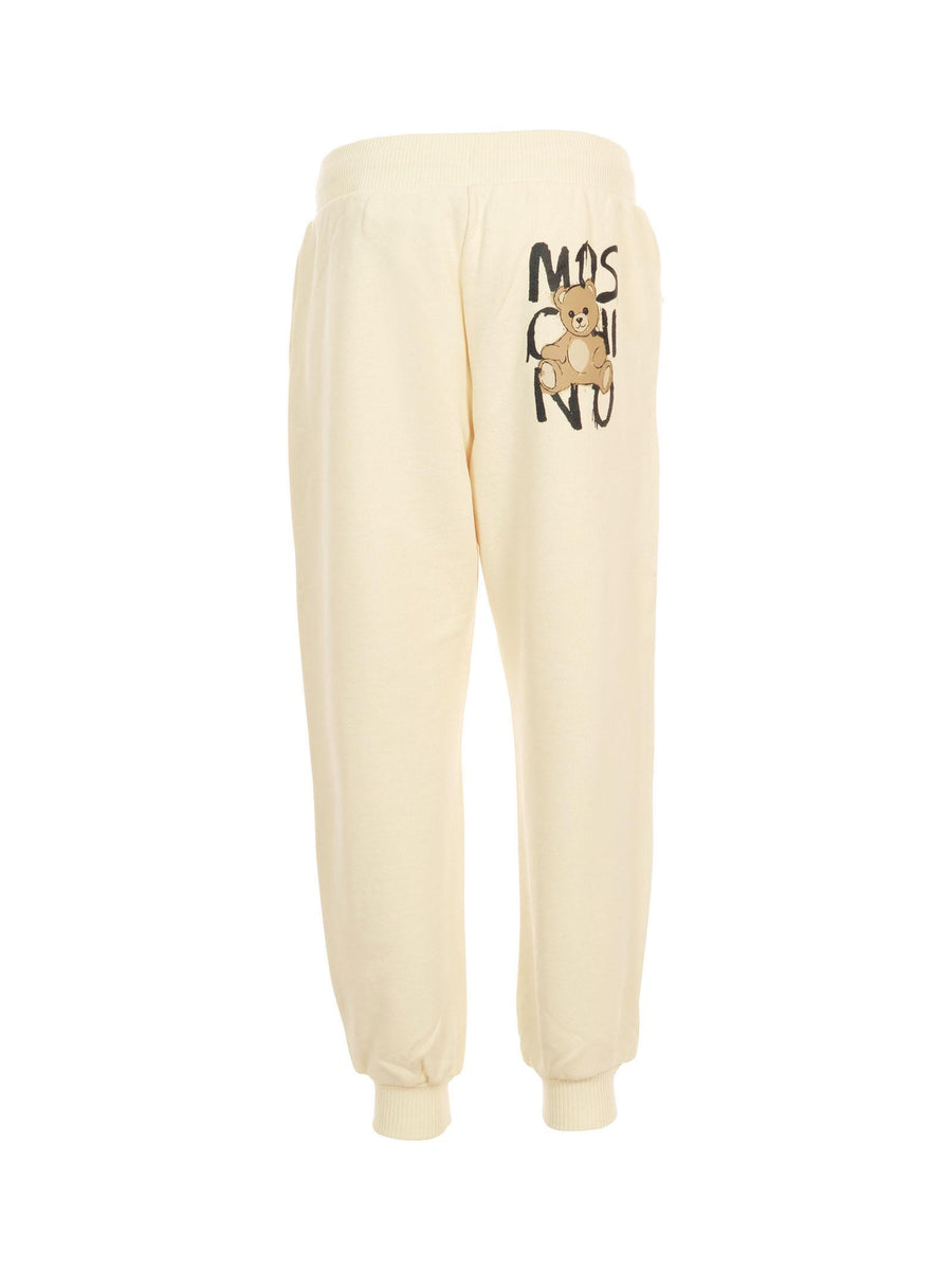 Pantalone in tuta Moschino avorio con tasche a zip e logo effetto pittura HUP08L 10123 Moschino 